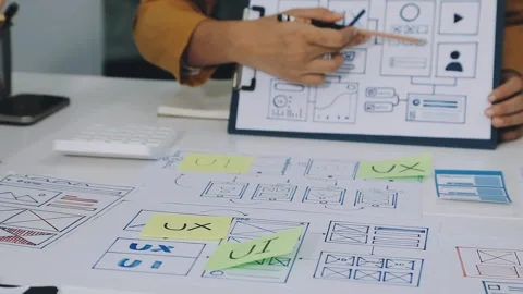 Group of young application developers analyzing uxui mobile app templates d.. Stock Footage 316828067