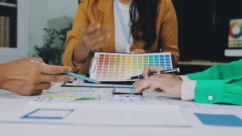 Group of young application developers analyzing uxui mobile app templates d.. Stock Footage 316828104