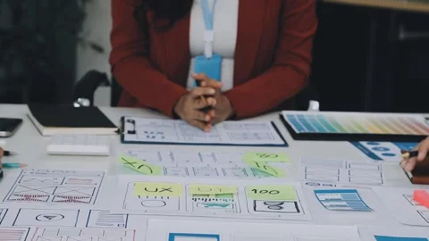 Group of young application developers analyzing uxui mobile app templates d.. Stock Footage 316828130