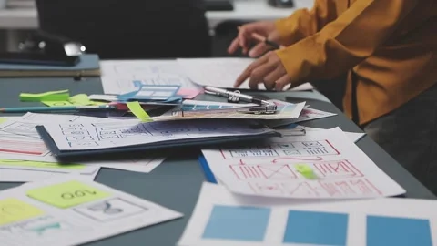 Group of young application developers analyzing uxui mobile app templates d.. Stock Footage 320526415