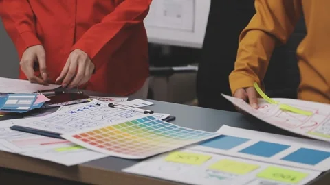 Group of young application developers analyzing uxui mobile app templates d.. Stock Footage 320526424