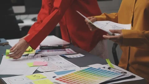 Group of young application developers analyzing uxui mobile app templates d.. Stock Footage 320526427