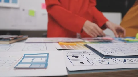 Group of young application developers analyzing uxui mobile app templates d.. Stock Footage 320526461