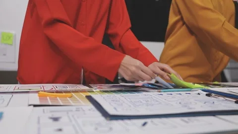 Group of young application developers analyzing uxui mobile app templates d.. Stock Footage 320526464