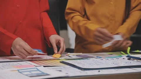 Group of young application developers analyzing uxui mobile app templates d.. Stock Footage 320526491