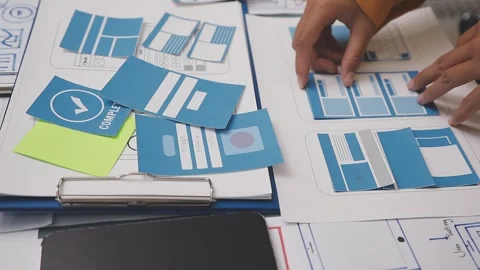 Group of young application developers analyzing uxui mobile app templates d.. Stock Footage 320526507
