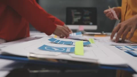 Group of young application developers analyzing uxui mobile app templates d.. Stock Footage 320526602