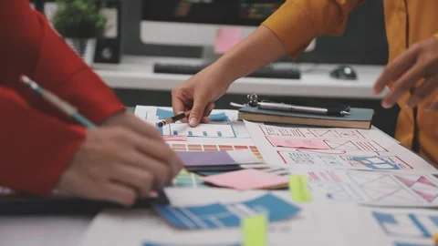 Group of young application developers analyzing uxui mobile app templates d.. Stock Footage 320526606
