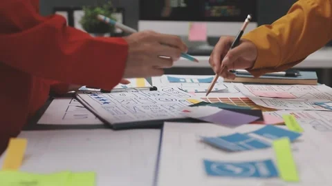 Group of young application developers analyzing uxui mobile app templates d.. Stock Footage 320526607