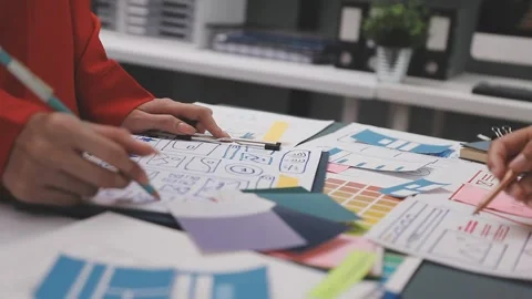 Group of young application developers analyzing uxui mobile app templates d.. Stock Footage 320526642
