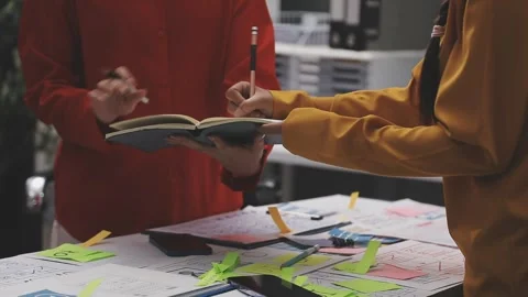 Group of young application developers analyzing uxui mobile app templates d.. Stock Footage 320526668
