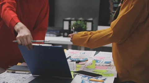 Group of young application developers analyzing uxui mobile app templates d.. Stock Footage 320526680
