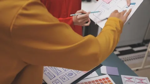 Group of young application developers analyzing uxui mobile app templates d.. Stock Footage 320526775