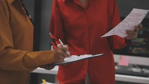 Group of young application developers analyzing uxui mobile app templates d.. Stock Footage 320526780