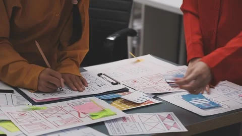 Group of young application developers analyzing uxui mobile app templates d.. Stock Footage 320526793