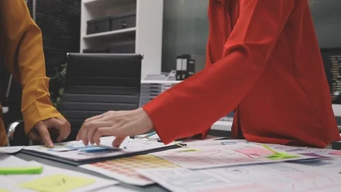 Group of young application developers analyzing uxui mobile app templates d.. Stock Footage 320526964