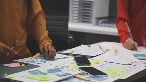Group of young application developers analyzing uxui mobile app templates d.. Stock Footage 320527030