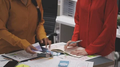 Group of young application developers analyzing uxui mobile app templates d.. Stock Footage 320527037
