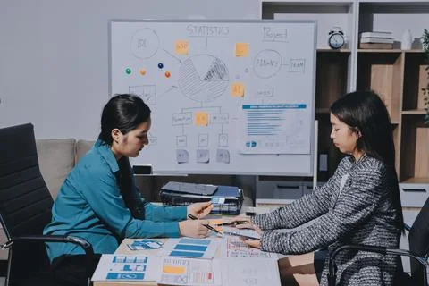 Group of young application developers analyzing uxui mobile app templates d.. Stock Photos