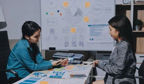 Group of young application developers analyzing uxui mobile app templates d.. Stock Photos