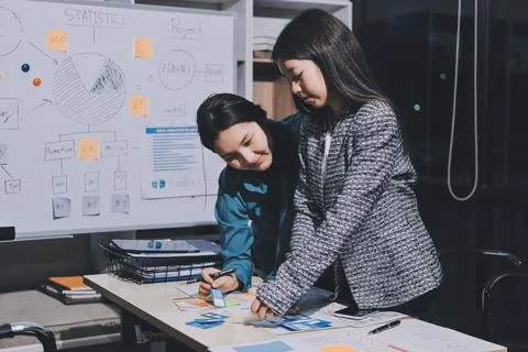 Group of young application developers analyzing uxui mobile app templates d.. Stock Photos