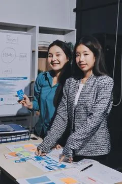 Group of young application developers analyzing uxui mobile app templates d.. Stock Photos