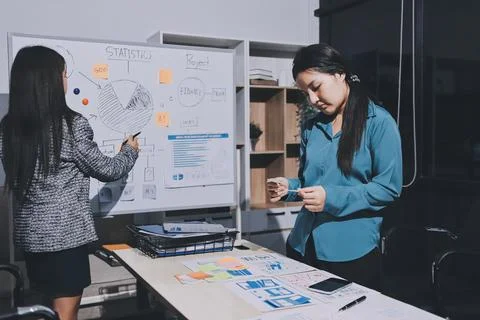 Group of young application developers analyzing uxui mobile app templates d.. Stock Photos