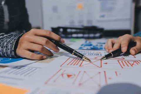 Group of young application developers analyzing uxui mobile app templates d.. Stock Photos
