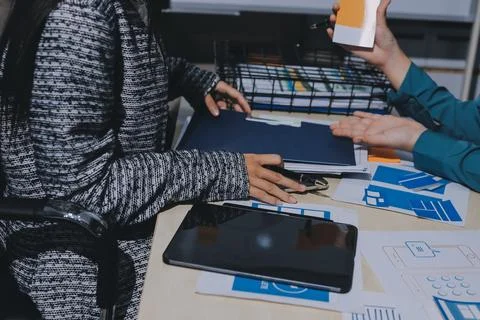 Group of young application developers analyzing uxui mobile app templates d.. Stock Photos