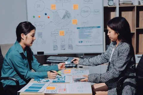 Group of young application developers analyzing uxui mobile app templates d.. Stock Photos