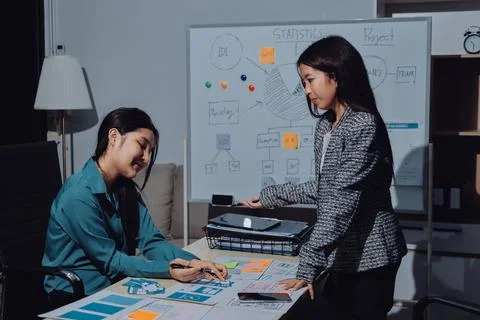 Group of young application developers analyzing uxui mobile app templates d.. Stock Photos