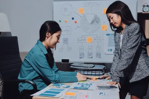 Group of young application developers analyzing uxui mobile app templates d.. Stock Photos