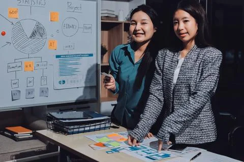 Group of young application developers analyzing uxui mobile app templates d.. Stock Photos