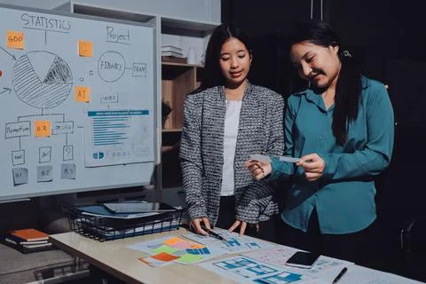 Group of young application developers analyzing uxui mobile app templates d.. Stock Photos