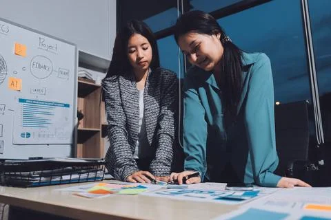 Group of young application developers analyzing uxui mobile app templates d.. Stock Photos