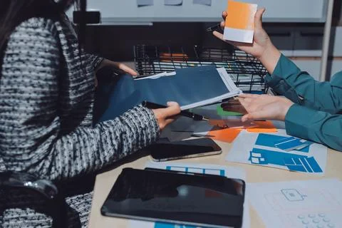 Group of young application developers analyzing uxui mobile app templates d.. Stock Photos