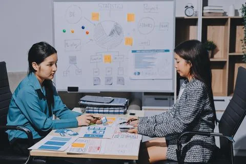 Group of young application developers analyzing uxui mobile app templates d.. Stock Photos