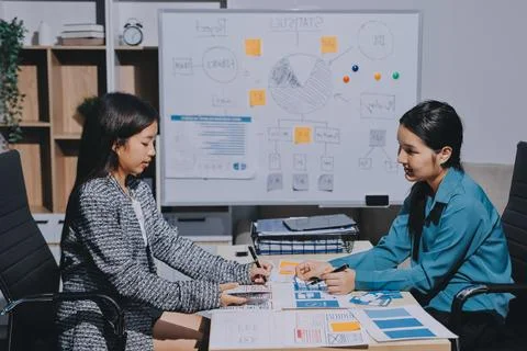 Group of young application developers analyzing uxui mobile app templates d.. Stock Photos