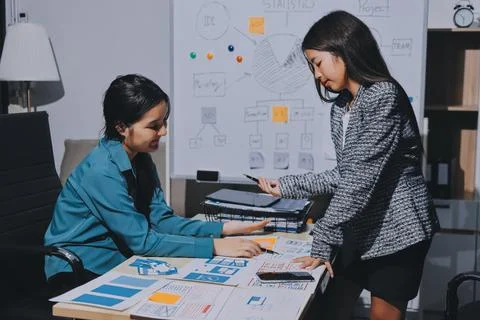 Group of young application developers analyzing uxui mobile app templates d.. Stock Photos