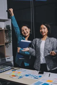 Group of young application developers analyzing uxui mobile app templates d.. Stock Photos