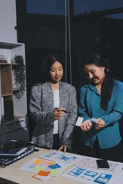 Group of young application developers analyzing uxui mobile app templates d.. Stock Photos