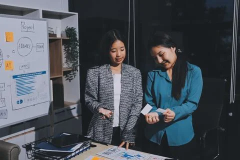 Group of young application developers analyzing uxui mobile app templates d.. Stock Photos
