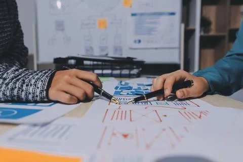 Group of young application developers analyzing uxui mobile app templates d.. Stock Photos