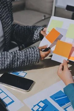 Group of young application developers analyzing uxui mobile app templates d.. Foto stock