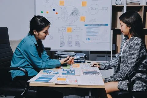 Group of young application developers analyzing uxui mobile app templates d.. Stock Photos