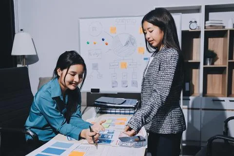Group of young application developers analyzing uxui mobile app templates d.. Stock Photos