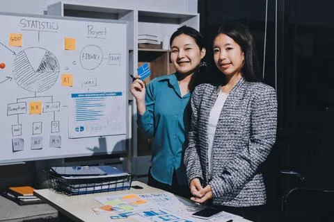 Group of young application developers analyzing uxui mobile app templates d.. Stock Photos