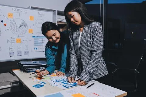 Group of young application developers analyzing uxui mobile app templates d.. Stock Photos