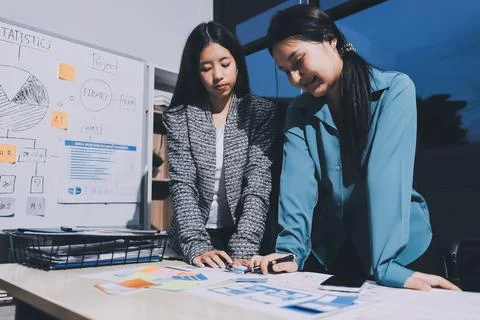 Group of young application developers analyzing uxui mobile app templates d.. Stock Photos