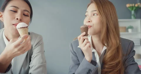 Group of young asia creative team workers enjoying eating ice cream. Stock Footage 194747129